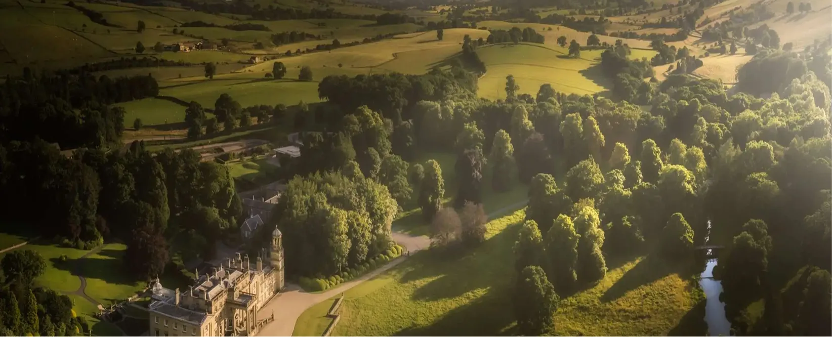 Aerial view of Broughton Hall set in its parkland and dales